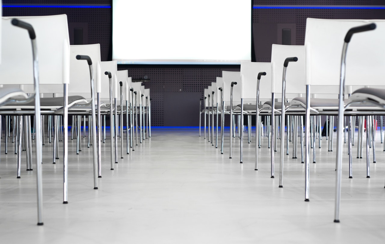 An conference hall with only empty chairs in the room